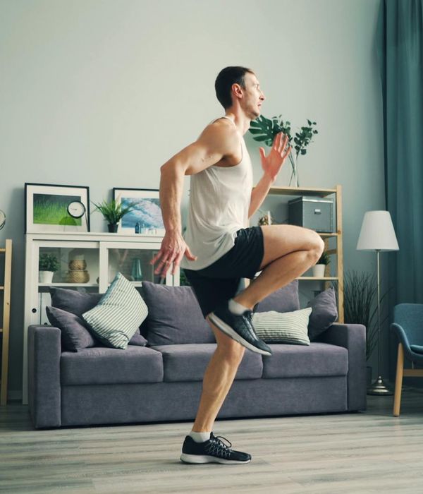 Person doing light cardio warming up exercises at home